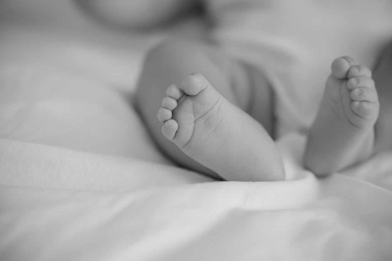 small-feet-of-a-baby-on-a-white-sheet.jpg